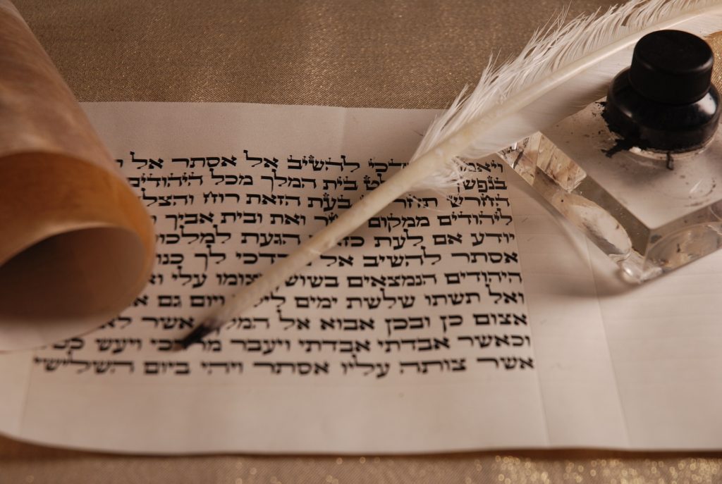 Hebrew letters on parchment with quill and ink well